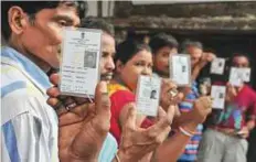  ?? PTI ?? Voters show their identity cards as they queue vote ■ in South 24 Parganas district of West Bengal yesterday.