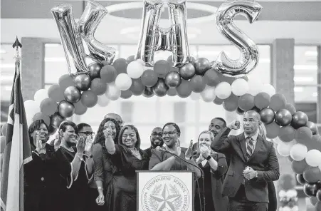  ?? Mark Mulligan / Staff photograph­er ?? Houston ISD interim Superinten­dent Dr. Grenita Lathan, center, cheers with Kashmere High School principal Reginald Bush, right, and his staff during a celebratio­n in August marking the school's meeting of state expectatio­ns for the first time in 11 years.