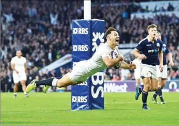  ?? GLYN KIRK/AFP ?? England’s Danny Care dives to score his second, and his team’s seventh, try during England’s Six Nations rugby match against Scotland at Twickenham Stadium on March 11.