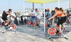  ?? Ahmed Ramzan/Gulf News ?? ■ Fitness enthusiast­s take part in a spinning session as part of a Dubai Fitness Challenge activity at Kite Beach yesterday.