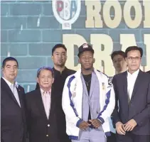  ?? ALVIN S. GO ?? THE COLUMBIAN DYIP made former NCAA MVP CJ Perez (in jacket) the first overall pick in the 2018 PBA Rookie Draft on Sunday.