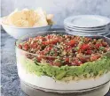  ?? [PHOTO BY JOE KELLER, AMERICA’S TEST KITCHEN/AP] ?? This ultimate seven layer dip recipe appears in the cookbook “All-Time Best Appetizers.”