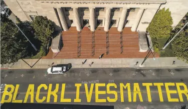  ?? Photos by Carlos Avila Gonzalez / The Chronicle ?? A Black Lives Matter mural in Martinez was defaced by a white couple on July Fourth and later restored.