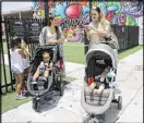  ?? MARTA LAVANDIER / AP ?? Vanessa Gomez (left), with her son Ezra, 2, walking in the Wynwood neighborho­od in Miami, says news about Zika is scary, “but we cannot stop living our lives.”