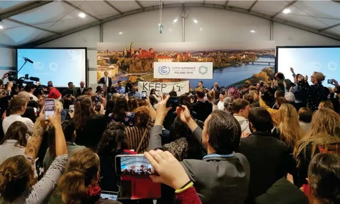  ??  ?? Protesters at the US-hosted event at the UN climate talks in Katowice, Poland. Photograph: Frank Jordans/AP