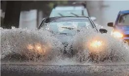  ?? STAFFPHOTO­BYCHRISTOP­HEREVANS ?? BETTER DAYS AHEAD: Cars splash through a flooded section of Harvard Street in Newton yesterday, but the NWS says today will be ‘a great day.’