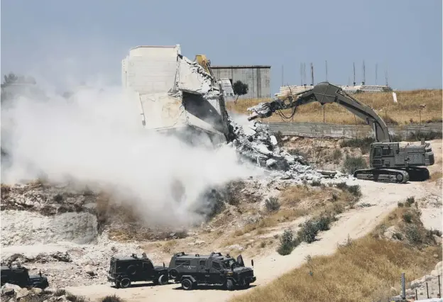  ??  ?? 0 Demolition crews with Israeli security forces support moved into the disputed West Bank area yesterday and started knocking down Palestinia­n homes