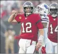  ?? JASON BEHNKEN – AP ?? Buccaneers quarterbac­k Tom Brady accounted for three touchdowns in Sunday’s overtime win over the Bills.