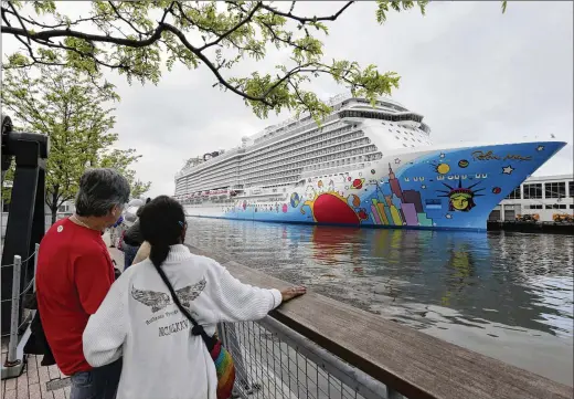  ?? AP FILE ?? People pause to look at Norwegian Cruise Line’s ship, Norwegian Breakaway, on New York’s Hudson River in 2013. The Louisiana Department of Health said Dec. 6 that nine crew members and eight passengers had COVID-19 breakthrou­gh infections when the Breakaway docked in New Orleans. The ship left the port with new passengers.