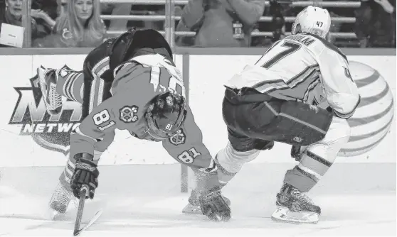  ?? | GETTY IMAGES ?? Marian Hossa was injured on this collision with Hampus Lindholm in the second period Saturday at the United Center.