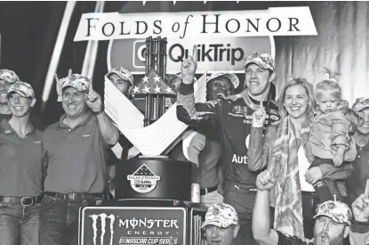  ?? PHOTOS BY SHANNA LOCKWOOD/USA TODAY SPORTS ?? Brad Keselowski poses with the trophy in victory lane Sunday after winning the Folds of Honor QuikTrip 500 at Atlanta Motor Speedway. Keselowski surged to the lead on the backstretc­h with six laps to go and held on for a 0.564-second victory.