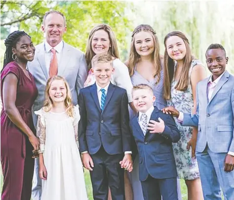 ?? Meredith Santucci / Twitt er ?? Amy Coney Barrett and her husband Jesse have seven children — five biological and two adopted. Their youngest child also has Down syndrome.