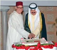  ?? — Photos by Fouad Al-Shaikh ?? KUWAIT: Deputy Foreign Ministers Khaled Al-Jarallah (right) and the Moroccan Ambassador to Kuwait Jaafar Hakeem cut the cake during a ceremony to celebrate Morocco’s national day on Monday.