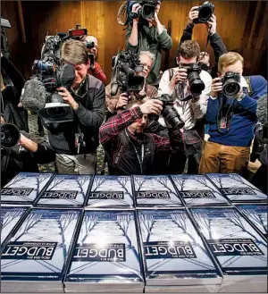  ?? AP/J. SCOTT APPLEWHITE ?? News photograph­ers get shots of President Barack Obama’s new $4 trillion budget plan Monday as it arrives on Capitol Hill in Washington.