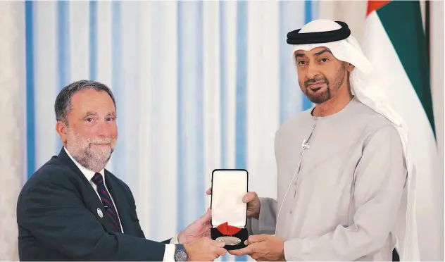  ?? ?? ↑
Sheikh Mohamed Bin Zayed receives the award from Dr Robert Satloff in Abu Dhabi.