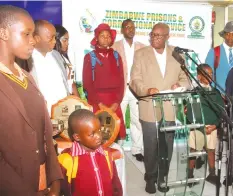  ?? Picture: Kudakwashe Hunda ?? The Commission­er-General of the Zimbabwe Prisons and Correction­al Services, Major-General (Retired) Paradzayi Zimondi delivers an address while surrounded by children who benefit from the organisati­on’s Goodwill Charity Fund in Harare yesterday. The ZPCS Commission­er-General’s Goodwill Charity Fund held its annual race day at Borrowdale Racecourse. Jockey Wes Marning, riding Sygone, won the main race.—