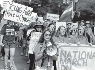  ?? Ronald Cortes / Contributo­r ?? Students march downtown as part of “March on NRA San Antonio," one of several such events happening across the country.