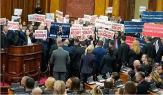  ?? ?? Opposition lawmakers hold banners reading: "Stole the elections" during a Serbia's parliament constituti­ve session in Belgrade, Serbia, Tuesday, Feb. 6, 2024.