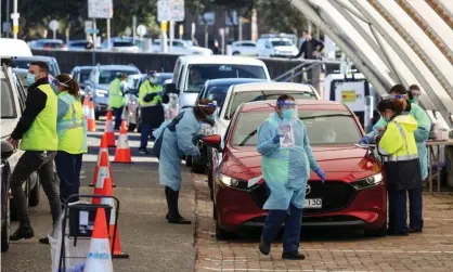  ?? Photograph:Loren Elliott/Reuters ?? Medical workers administer tests at the Bondi beach Covid testing centre in Sydney