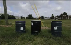  ?? PHOTOS BY THE ASSOCIATED PRESS ?? Barrels identified by stickers as IDW, or “investigat­ion derived waste,” full of soil and water sit in a field designated by the EPA as an intensely polluted Superfund site called Anodyne North Miami Beach on Sept. 6.