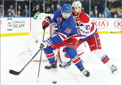  ??  ?? Chris Kreider #20 of the New York Rangers controls the puck in front of Karl Alzner #27 of the Washington Capitals in Game One of the Eastern Conference
Semifinals during the 2015 NHL Stanley Cup Playoffs at Madison Square Garden on April 30, in New...