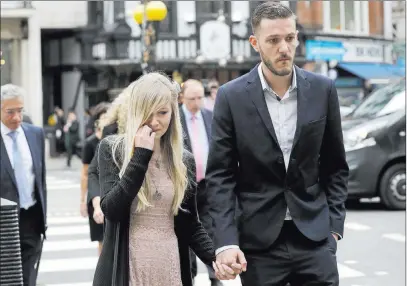  ?? Matt Dunham ?? The Associated Press The parents of Charlie Gard, Connie Yates and Chris Gard, arrive Monday at the High Court in London, where they agreed to let their child be taken off life support. The decision came after medical tests showed the 11-month-old has irreversib­le muscular damage.