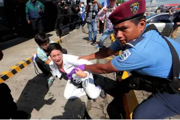  ??  ?? Riot police detain a protester during a march called “United for freedom” against Ortega in Managua. — Reuters photo