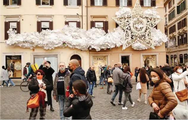  ?? R euters ?? ↑ People wear protective masks as they walk on Piazza di Spagna in Rome, Italy.