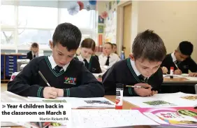  ?? Martin Rickett/PA ?? Year 4 children back in the classroom on March 8