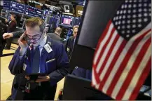  ?? RICHARD DREW / AP ?? Trader Gregory Rowe works Monday at the New York Stock Exchange. The Dow saw its biggest one-day gain in points ever Monday, which erased much of the recent tumble fueled by virus fears.