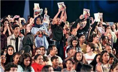  ?? Photo by M. Sajjad ?? Youths cheer with LiLLy Singh’s book in their hands as the YouTuber speaks at the book fair. —