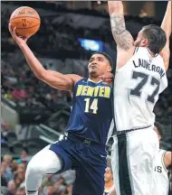  ?? DARREN ABATE / AP ?? Denver Nuggets’ Gary Harris shoots against San Antonio Spurs' Joffrey Lauvergne during Sunday’s preseason game in San Antonio.