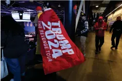  ?? ?? An attendee wears a flag during a campaign rally for Former president Donald Trump Saturday Dec. 16, 2023, in Durham, N.H. (AP Photo/ Reba Saldanha)