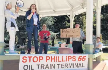  ?? Robin Abcarian Los Angeles Times ?? ARLENE BURNS, mayor of Mosier, Ore., second from left, speaks at a rally against crude-by-rail in Santa Maria, Calif. She told what happened June 7, when an oil train derailed near a school and a water plant.