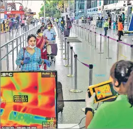  ?? PTI ?? Passengers undergo thermal scanning on arrival at the Bengaluru airport on Monday.