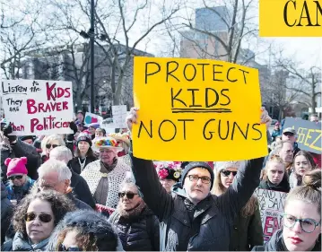  ?? GRAHAM HUGHES / THE CANADIAN PRESS ?? People hold up signs during a “March for Our Lives” rally to show solidarity with the U.S. gun control movement in Montreal on Saturday. More than a dozen Canadian cities hosted marches to call for stricter gun control laws.