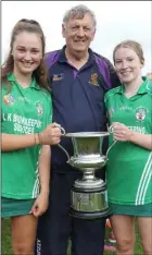  ??  ?? Cloughbawn’s joint captains, Rebecca Ogilvie and Elizabeth Dempsey, receiving the trophy from Ray Quigley.