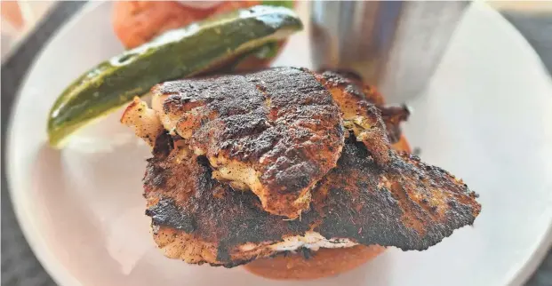  ?? WADE TATANGELO/SARASOTA HERALD-TRIBUNE ?? The grouper sandwich, which comes blackened at Beach House on Bradenton Beach, Anna Maria Island