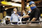  ?? AP ?? Joe Biden (left) tours a metal fabricatin­g facility in Pennsylvan­ia last week. Biden is pledging to define his presidency by a sweeping economic agenda.