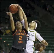  ?? ROD AYDELOTTE — WACO TRIBUNE-HERALD ?? Big 12: Baylor guard Trinity Oliver, right, blocks the shot of Oklahoma State guard Neferatali Notoa on Feb. 24 in Waco, Texas.