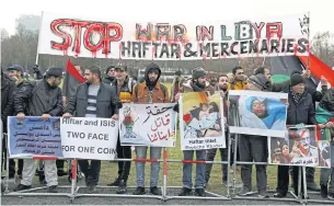  ?? REUTERS ?? Protesters against Libyan commander Khalifa Haftar gather in front of the Chanceller­y during the Libya summit in Berlin, Germany on Jan 19.