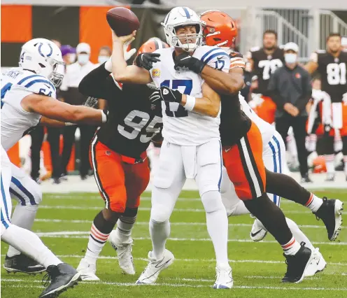  ?? GREGORY SHAMUS / GETTY IMAGES FILES ?? Colts quarterbac­k Philip Rivers gets hit by Olivier Vernon of the Browns on Sunday. One undeniable effect of the penalty plunge? Scoring is way up — on a record pace. Never before had teams, combined, scored 453 touchdowns or 3,958 points through Week 5, as this season, John Kryk writes.