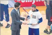  ?? JOSE CARLOS FAJARDO — BAY AREA NEWS GROUP FILE ?? Golden State Warriors general manager Bob Myers, left, gives Stephen Curry an award before the start of their game at Chase Center in San Francisco on May 14.