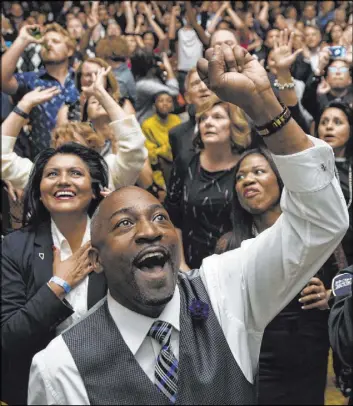  ?? Benjamin Hager Las Vegas Review-Journal ?? Assemblyma­n Tyrone Thompson, center, cheers as results come in for thenCongre­sswoman Jacky Rosen during an election night event Nov. 6 at Caesars Palace.