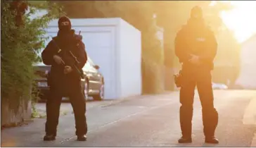  ?? AFP ?? Special forces police officers stand on the street near a refugee shelter yesterday in Ansbach where the Syrian migrant who set off an explosive device had stayed.