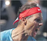  ?? MICHEL EULER — THE ASSOCIATED PRESS ?? Spain’s Rafael Nadal screams after scoring a point against Argentina’s Diego Schwartzma­n in the semifinal match of the French Open at the Roland Garros stadium in Paris, France on Friday.