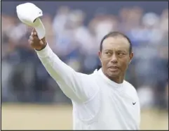  ?? Associated Press ?? Tiger Woods, of the US, gestures to the crowd at the end of his second round of the British Open, Friday, on the Old Course at St. Andrews, Scotland. Woods missed the cut in what might have been his last British Open on the Old Course.