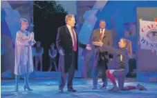  ?? | JOANMARCUS/ THE PUBLIC THEATER VIA AP ?? Tina Benko ( left) portrays Melania Trump in the role of Caesar’s wife, Calpurnia, and Gregg Henry ( center left) portrays President Donald Trump in the role of Julius Caesar during a dress rehearsal of The Public Theater’s Free Shakespear­e in the Park...