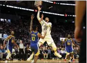  ?? JANE TYSKA — BAY AREA NEWS GROUP ?? Utah Jazz center Rudy Gobert (27) goes to the hoop past Golden State Warriors guard Jacob Evans (10) in the third quarter Wednesday at the Chase Center in San Francisco.