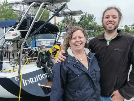  ?? DAVE SIDAWAY ?? Carole Plouffe, her husband, Benoit Plamondon, and their two young kids, 12-year-old Ludvik, in yellow, and Kilian, 8, are living on their sailboat Intuition in the La Ronde marina. The family plans to depart in September for their year-long trip from Montreal to the Caribbean.